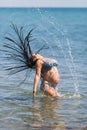 Pregnant woman in swimwear splashing water with her hair Royalty Free Stock Photo