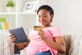 Pregnant woman with tablet pc and credit card Royalty Free Stock Photo