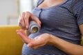 Close Up Of Pregnant Woman Taking Folic Acid Tablets