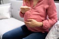 Pregnant Woman Taking Vitamin Pill. Folic Acid