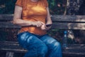 Pregnant woman texting outdoors Royalty Free Stock Photo