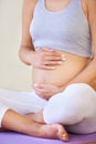 Pregnant woman, touch stomach and fitness in studio with relax wellness and exercise for prenatal care. Person, yoga mat Royalty Free Stock Photo