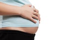 Pregnant woman touching or bonding her abdomen