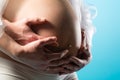 Pregnant woman touching her belly or baby bump