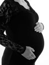 Pregnant woman touching her belly with hands, on white background Royalty Free Stock Photo