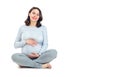 Pregnant woman touching her belly. Healthy pregnancy concept. Pregnant middle aged gravid woman sitting isolated on white