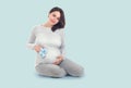 Pregnant Woman touching her belly. Pregnant middle aged mother`s hands caressing her tummy. Healthy Pregnancy concept