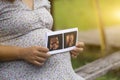 Pregnant woman touching her big belly