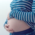 Pregnant woman touching and rubbing her belly Royalty Free Stock Photo