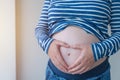 Pregnant woman touching and rubbing her belly Royalty Free Stock Photo
