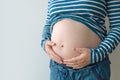 Pregnant woman touching and rubbing her belly Royalty Free Stock Photo