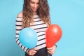 Pregnant woman tries to guess the boy or girl. Balloons as symbol of boy and girl.