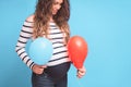 Pregnant woman tries to guess the boy or girl. Balloons as symbol of boy and girl.