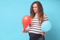 Pregnant woman tries to guess the boy or girl. Balloons as symbol of boy and girl.