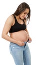 Pregnant woman trying to close zip on the jeans Royalty Free Stock Photo