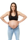Pregnant woman trying to fit in tight jeans Royalty Free Stock Photo