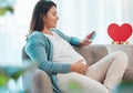 Pregnant woman, ultrasound and mother on sofa in home looking at picture. Pregnancy, sonography and happy female in Royalty Free Stock Photo