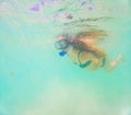 Pregnant woman underwater swimming in tropical sea. Healthy and active pregnancy. Young expecting mom on summer beach Royalty Free Stock Photo