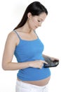 Pregnant woman using calculator Royalty Free Stock Photo