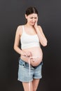 pregnant woman using tape measure to check baby development and the growth of belly. Inch measurement