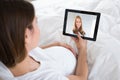 Pregnant Woman Videoconferencing With Doctor