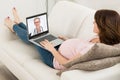 Pregnant Woman Videoconferencing With Doctor