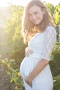 Pregnant woman in vineyard is standing infront Royalty Free Stock Photo