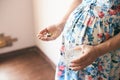 Pregnant woman waiting for baby and taking vitamins Royalty Free Stock Photo