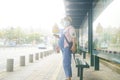 Shenzhen, China: A pregnant woman is waiting for a bus at a bus stop
