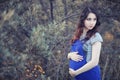 Pregnant woman on a walk in the park Royalty Free Stock Photo