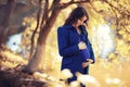 Pregnant woman on a walk in the park Royalty Free Stock Photo