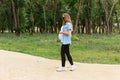 Pregnant woman on a walk in the park Royalty Free Stock Photo