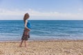 Pregnant woman walking on the beach Royalty Free Stock Photo