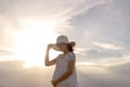 Pregnant woman walking on the beach at sunset Royalty Free Stock Photo