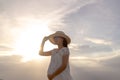 Pregnant woman walking on the beach at sunset Royalty Free Stock Photo