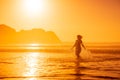 Pregnant woman walking on ocean beach at beach with sunrise or sunset Royalty Free Stock Photo