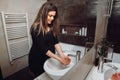 Pregnant woman washing hands with soap under the faucet with water at home in bathroom Royalty Free Stock Photo