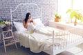 Pregnant woman watching films and having breakfast in bed Royalty Free Stock Photo