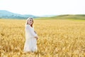 Pregnant woman in wheat field Royalty Free Stock Photo