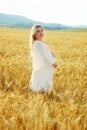 Pregnant woman in wheat field Royalty Free Stock Photo