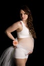 Pregnant woman in white bra with lace and flower looking