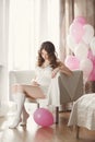 Pregnant woman in a white nightgown with balloons. Royalty Free Stock Photo