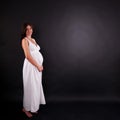 Pregnant woman in white plain dress