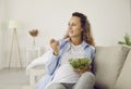 Pregnant woman who eats many different vegetables during pregnancy enjoys fresh green salad at home. Royalty Free Stock Photo