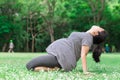 Pregnant woman work out in the green garden. Royalty Free Stock Photo