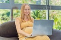 Pregnant woman working on laptop. Expectant woman efficiently works from home during pregnancy, blending professional Royalty Free Stock Photo
