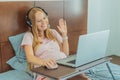 Pregnant woman working on laptop. Expectant woman efficiently works from home during pregnancy, blending professional Royalty Free Stock Photo