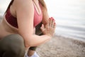 Pregnant woman working yoga on the beach. Royalty Free Stock Photo