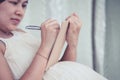 Pregnant woman writing in notebook to list necessary things