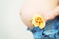 Pregnant woman with yellow flower